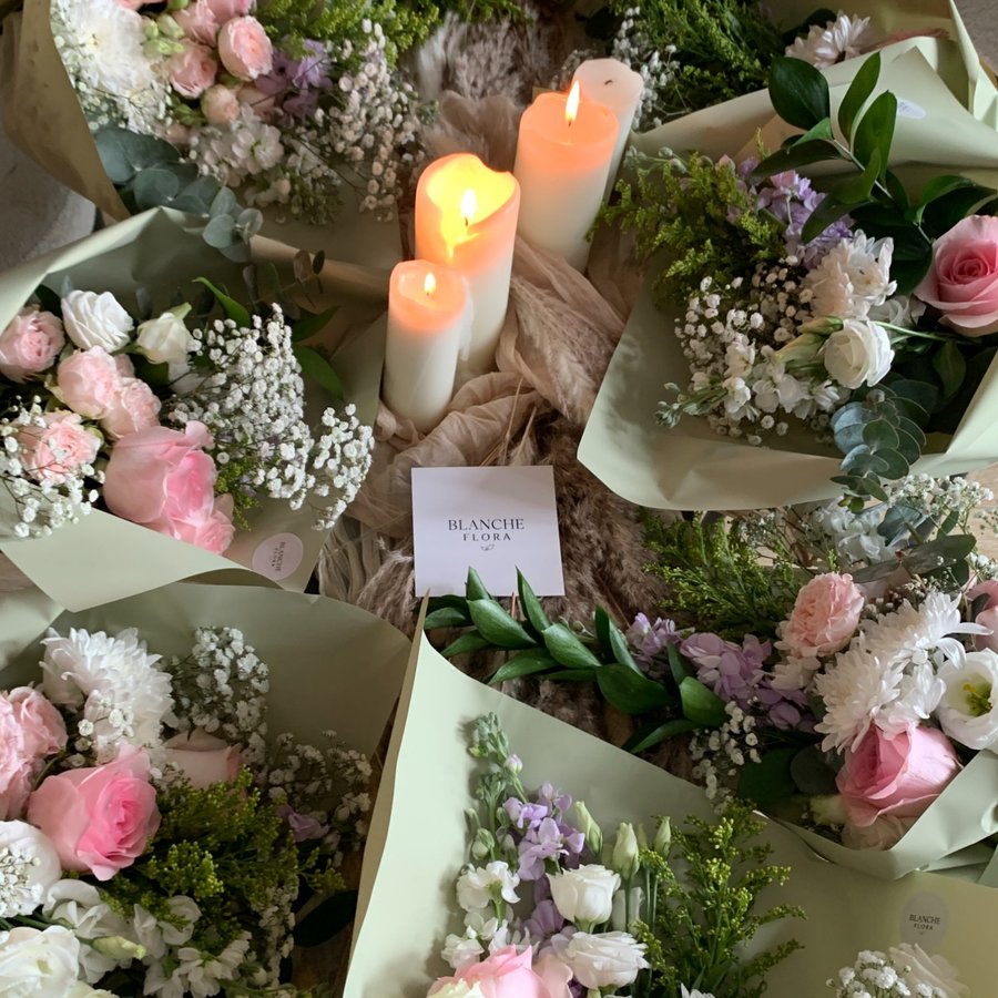 Workshop bouquets laid out with candles